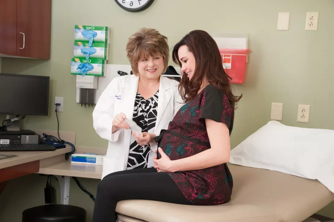 Nursing student examining a pregnant woman